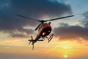 Helicopter in the air at sunset