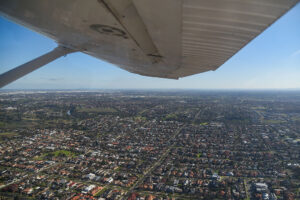 Vire from light plane under wing over suburbs